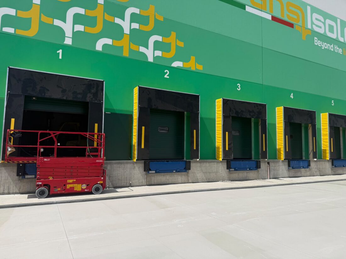 Sistemi per la logistica e punti di carico con portoni sezionali e baie isotermiche per lo stabilimento TransIsole